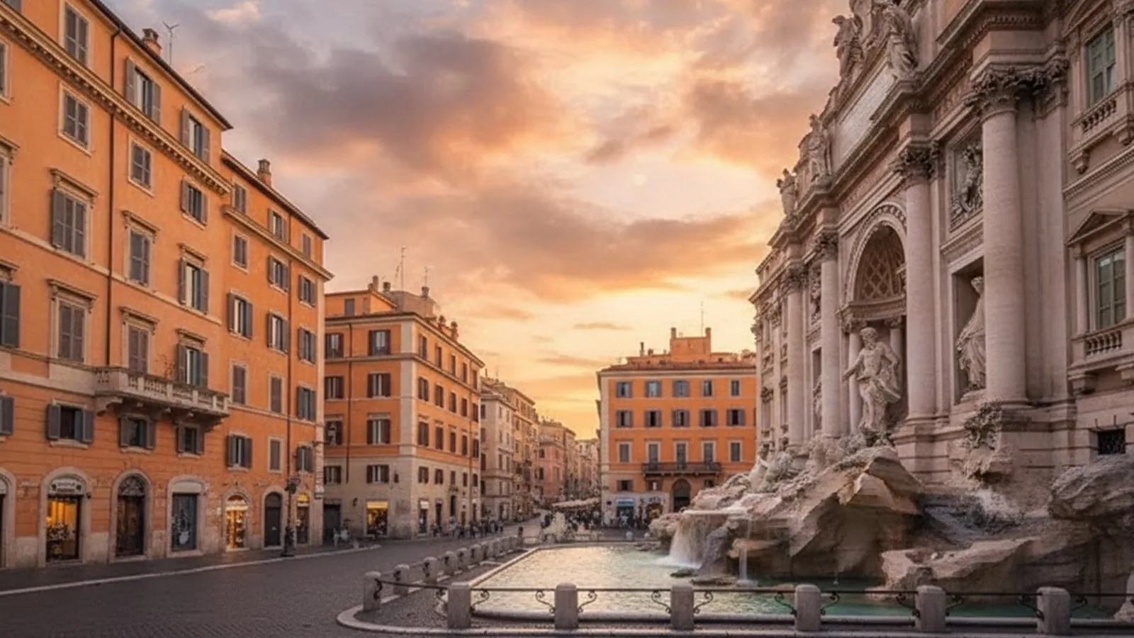 La Fontana di Trevi a Roma al tramonto, con i palazzi della piazza illuminati